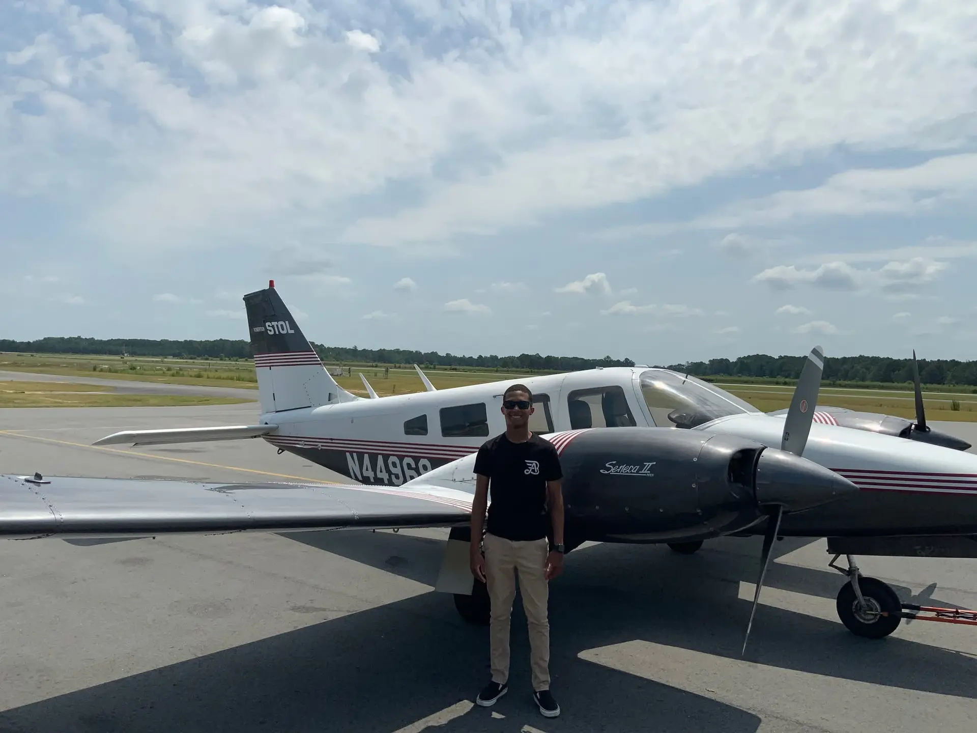 Jaden E. standing next to a training aircraft at M2A Aviation Academy