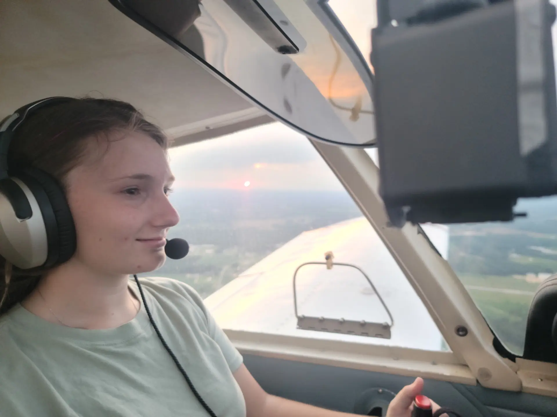 Savannah K. inside the cockpit of a training aircraft at M2A Aviation Academy