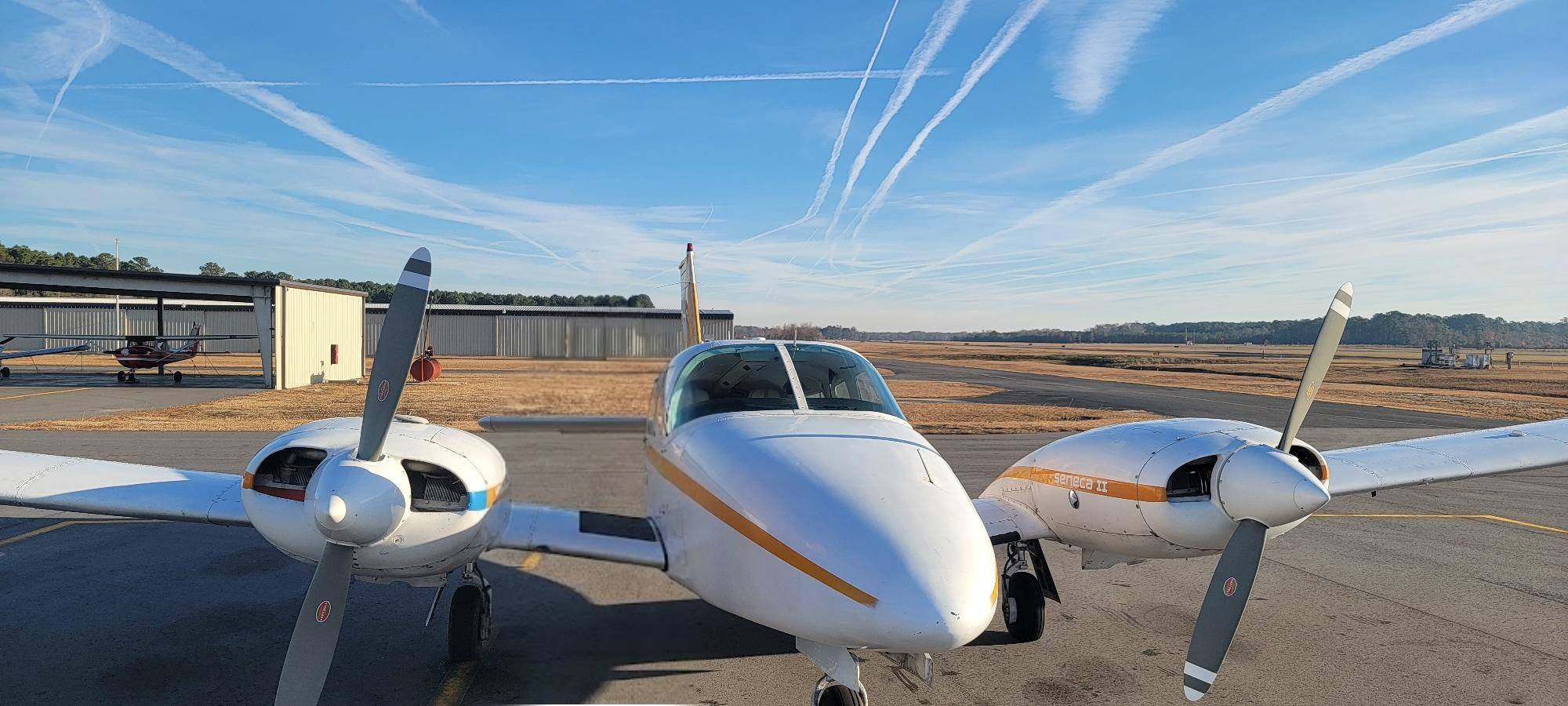 Training aircraft flying under a clear sky in North Carolina