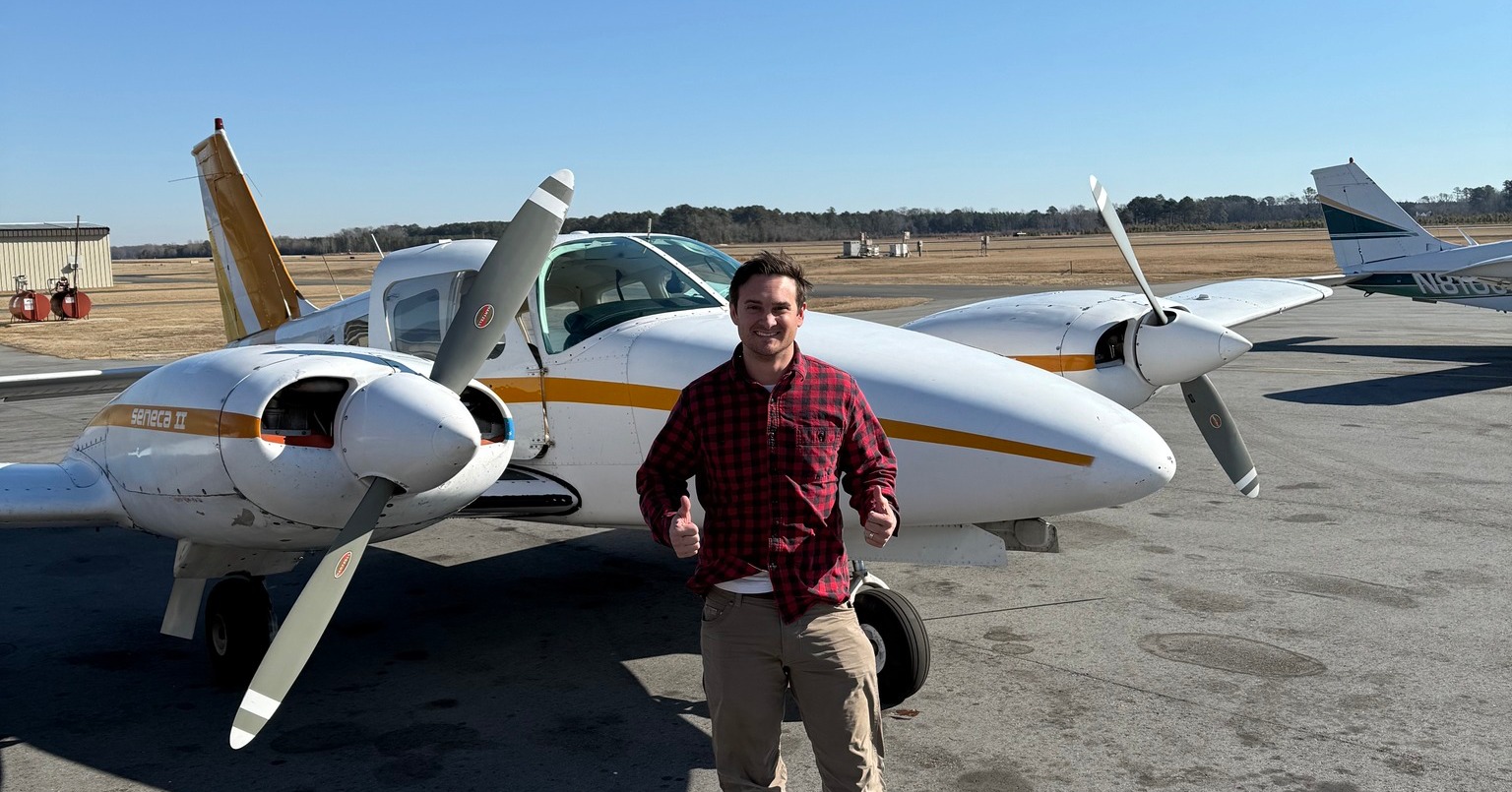M2A Aviation Academy student posing in front of Piper aircraft equipped with Garmin G3X glass cockpit