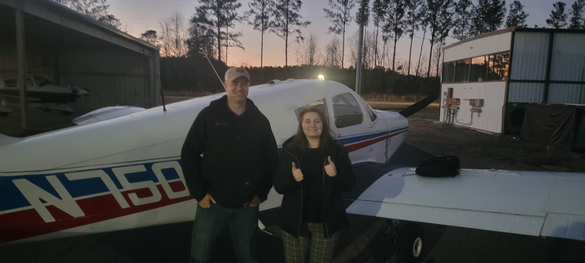 Commercial pilot course graduate Savana F. with her flight instructor at M2A Aviation Academy