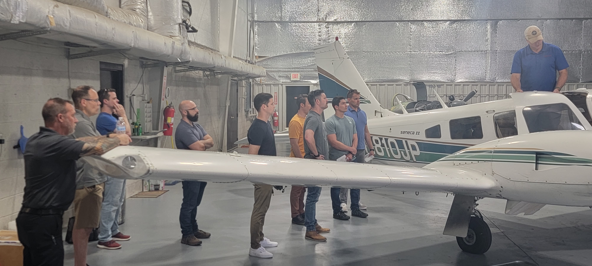 M2A Aviation Academy students gathered inside the hangar during professional pilot training